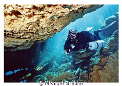 Side-mount diver entering the cavern section at Peacock S... by Michael Grebler 